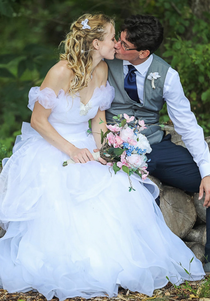 Bride and groom kissing outdoors