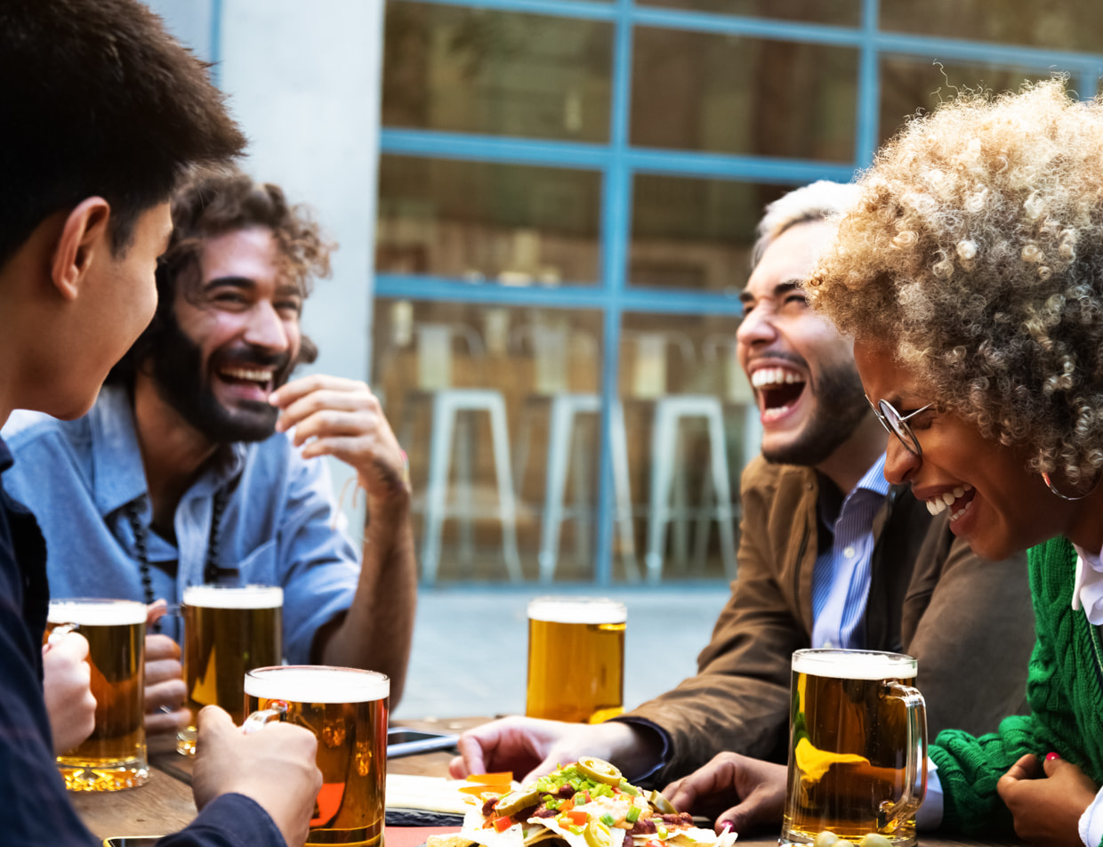 Friends laughing while drinking beer