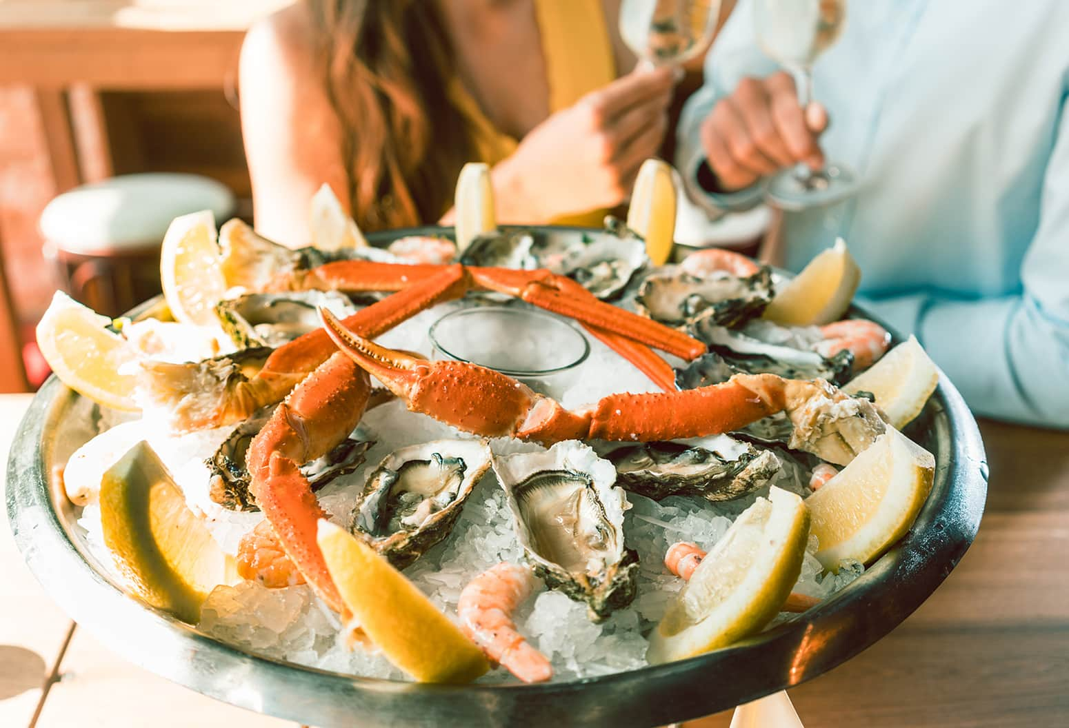 Couple eating various types of seafood